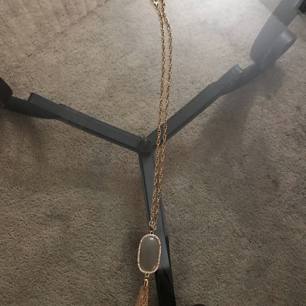 Long gold plated necklace with jewel.